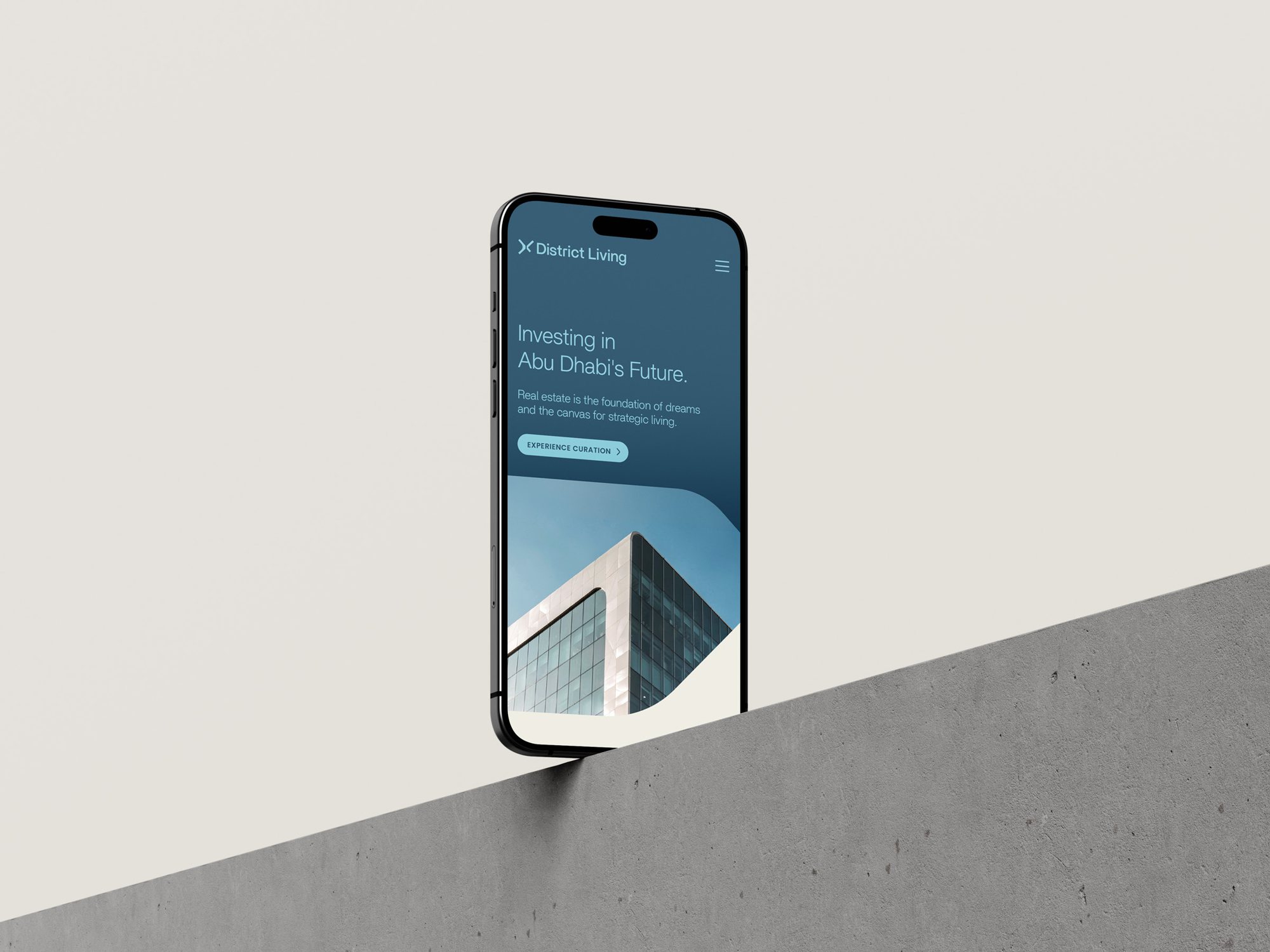 The website shown on a phone standing on a concrete edge
